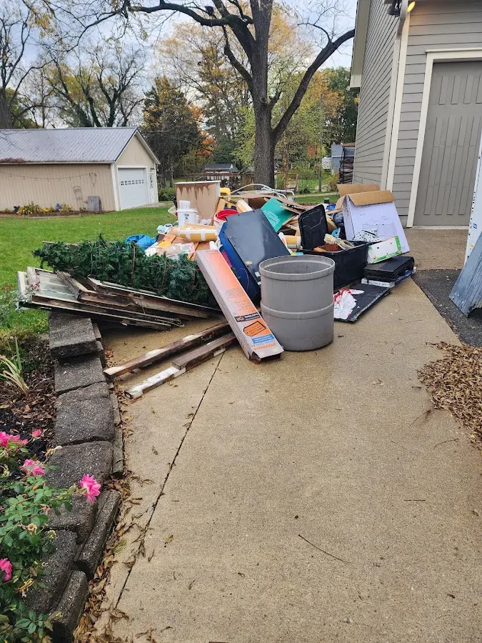 Dumpster being loaded with debris for 30 Yard Dumpster Rental in Ames